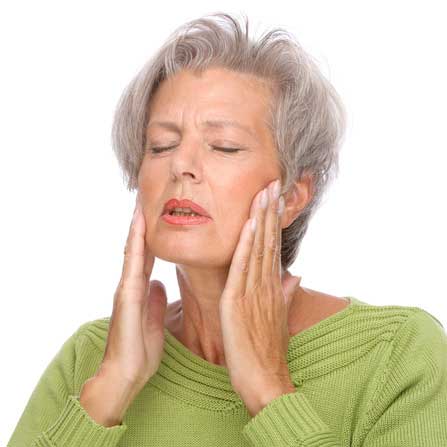 Senior lady holding her mouth in pain