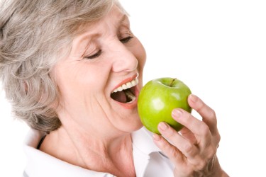 Old age women eating apple