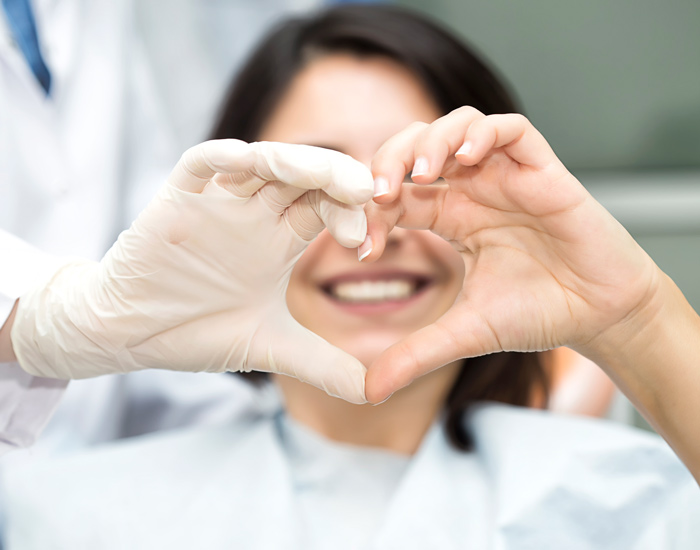 patient and doctor making a heart with their hands