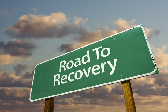 Road To Recovery Green Road Sign with dramatic view
