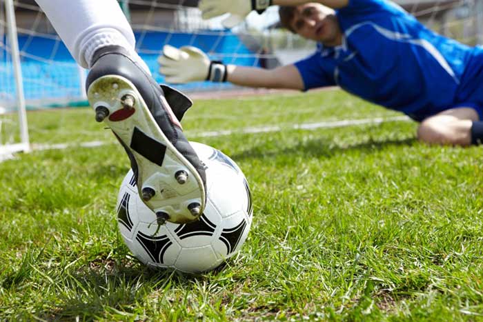 Football player kicking a football