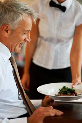 Senior man setting in hotel table